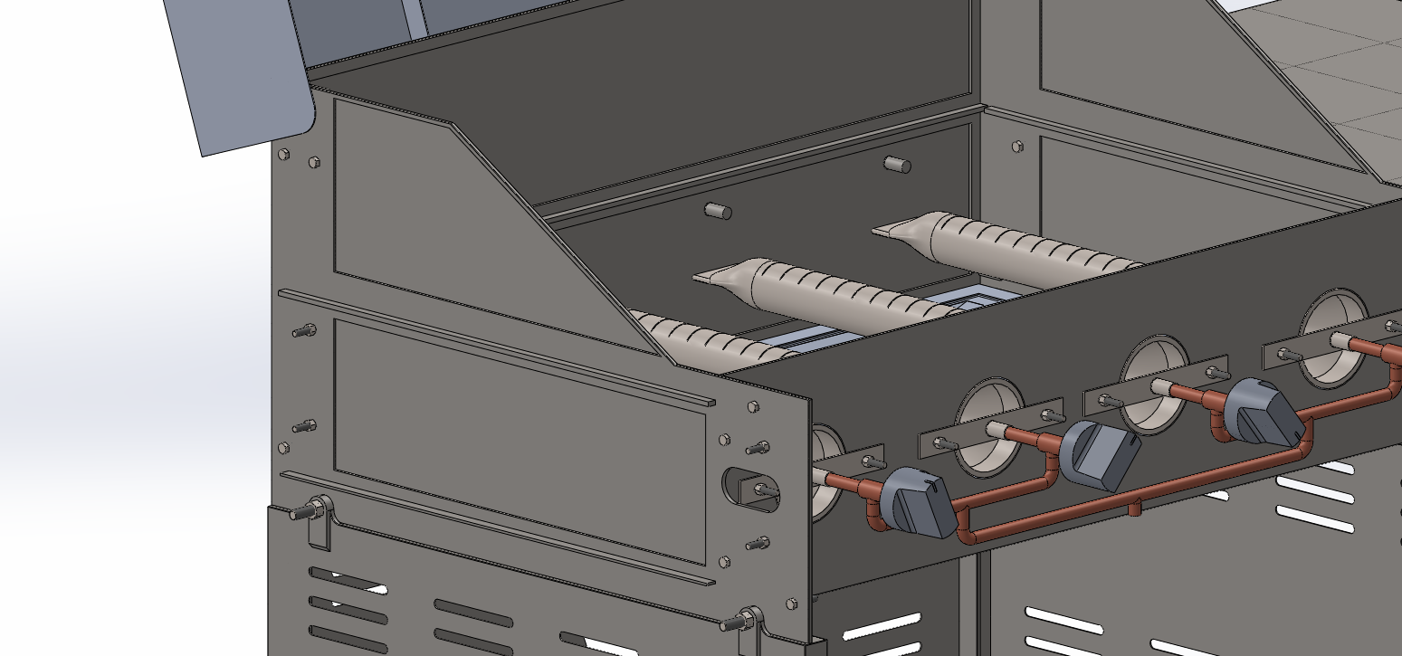 Close view into the firebox from the side showing burners, valve bodies and knobs
