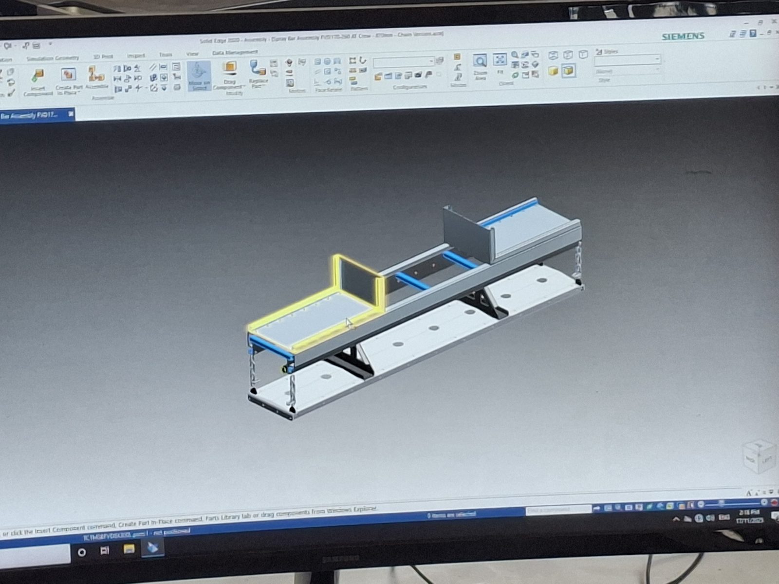 A steel subassembly modelled in CAD on a workshop monitor