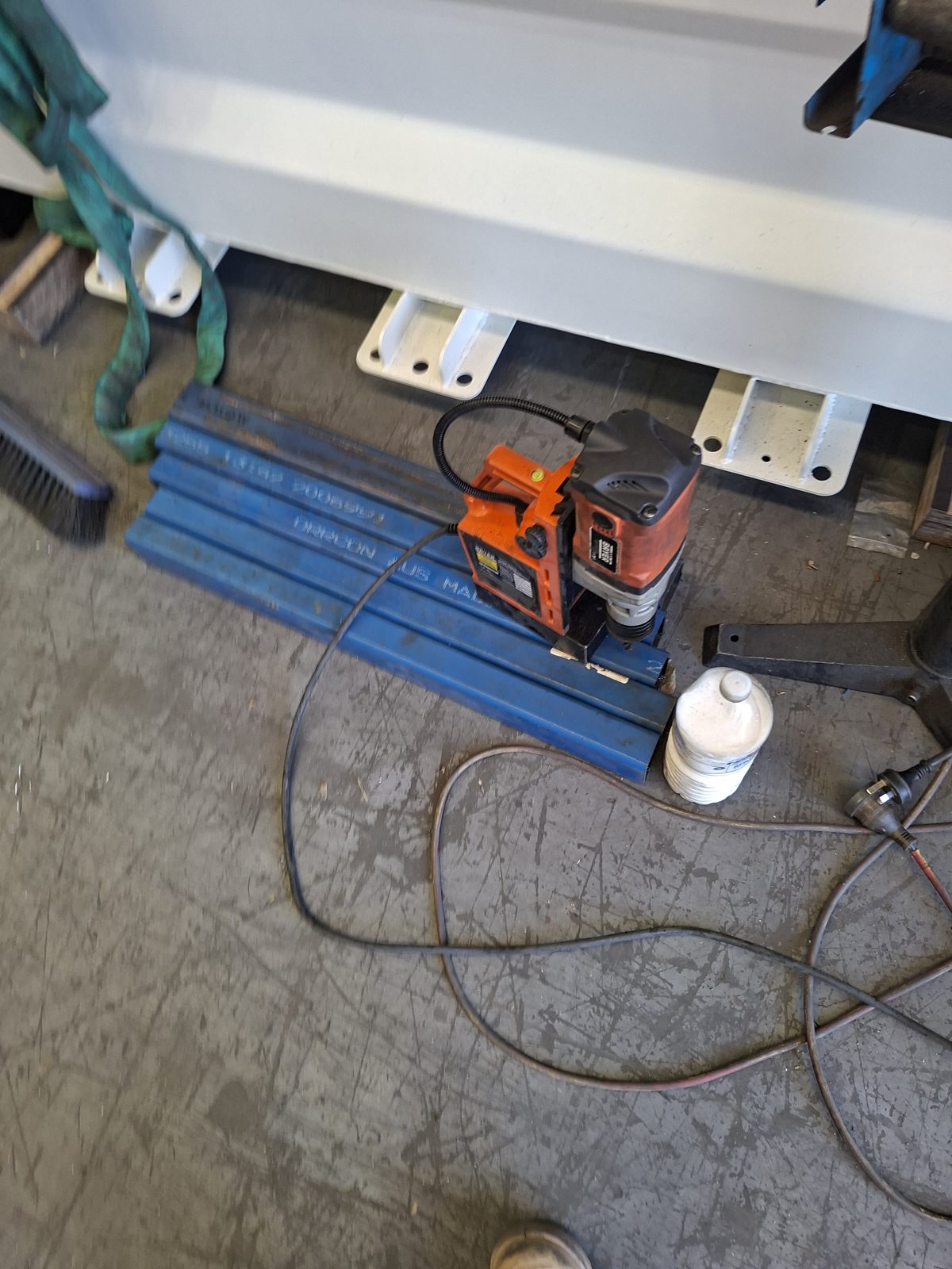 Magnetic drill press set up on a C-beam section on the workshop floor