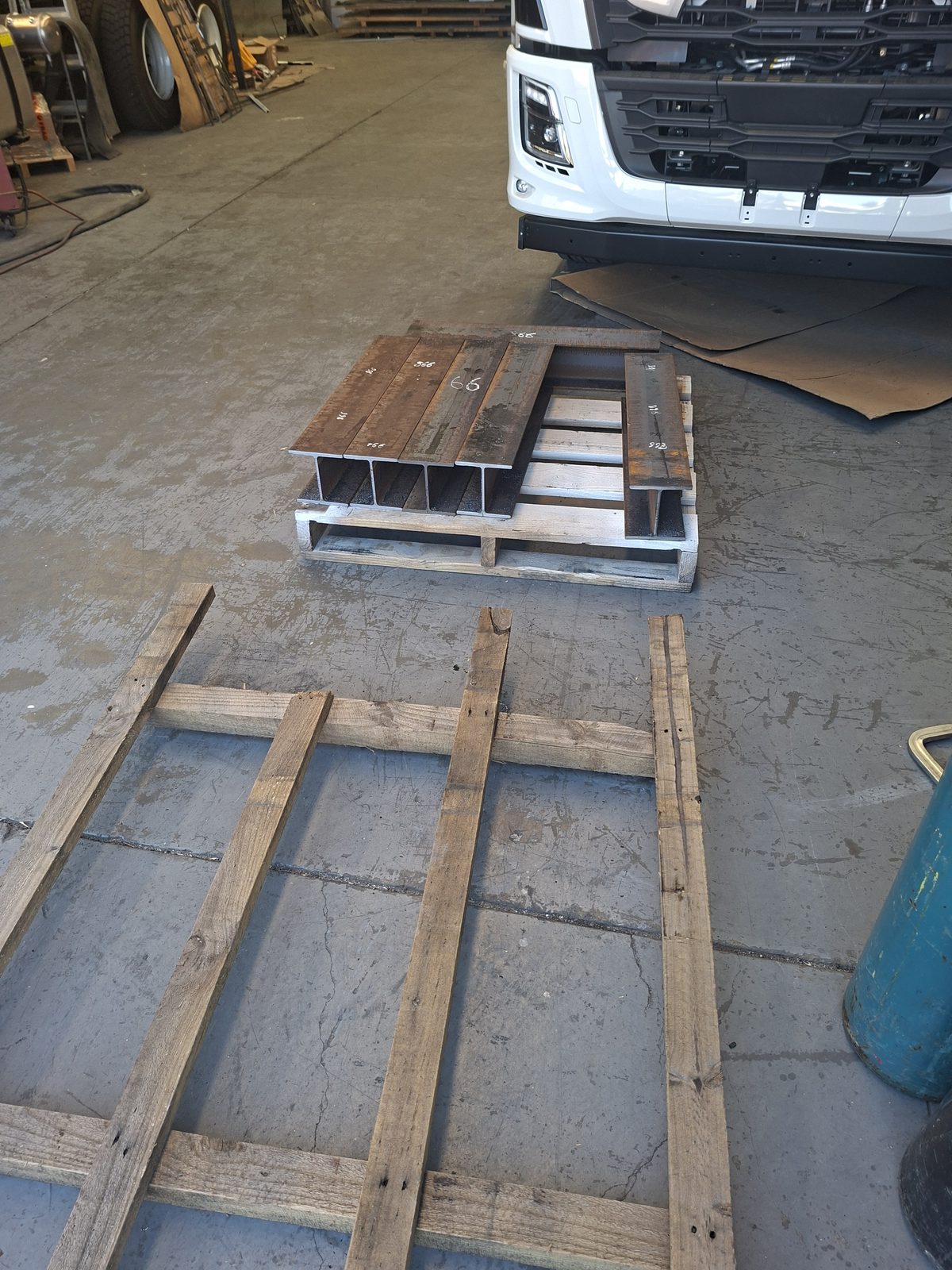 Cut beams being loaded onto pallets
