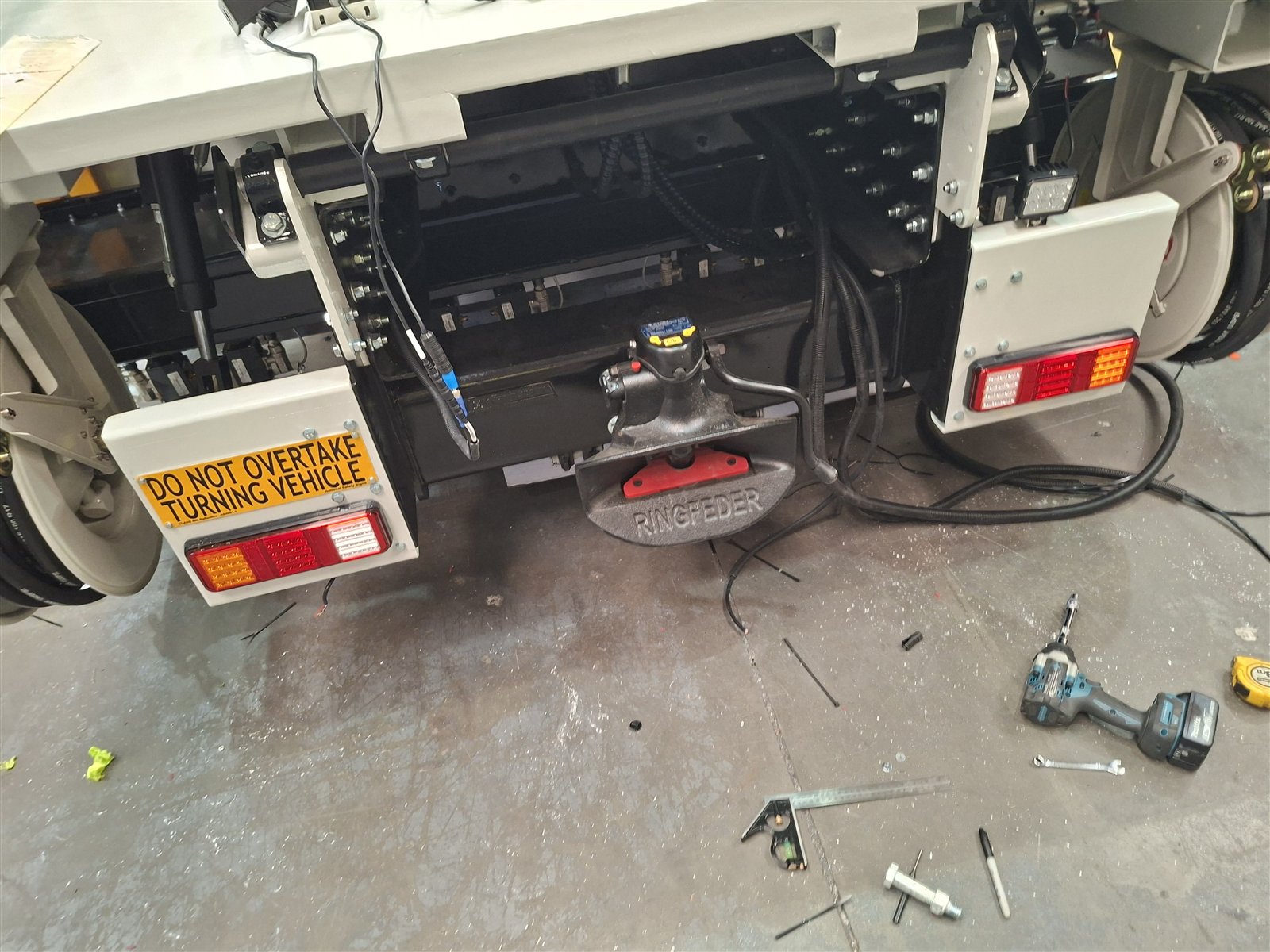 Finished rear with tail lights and do-not-overtake signage