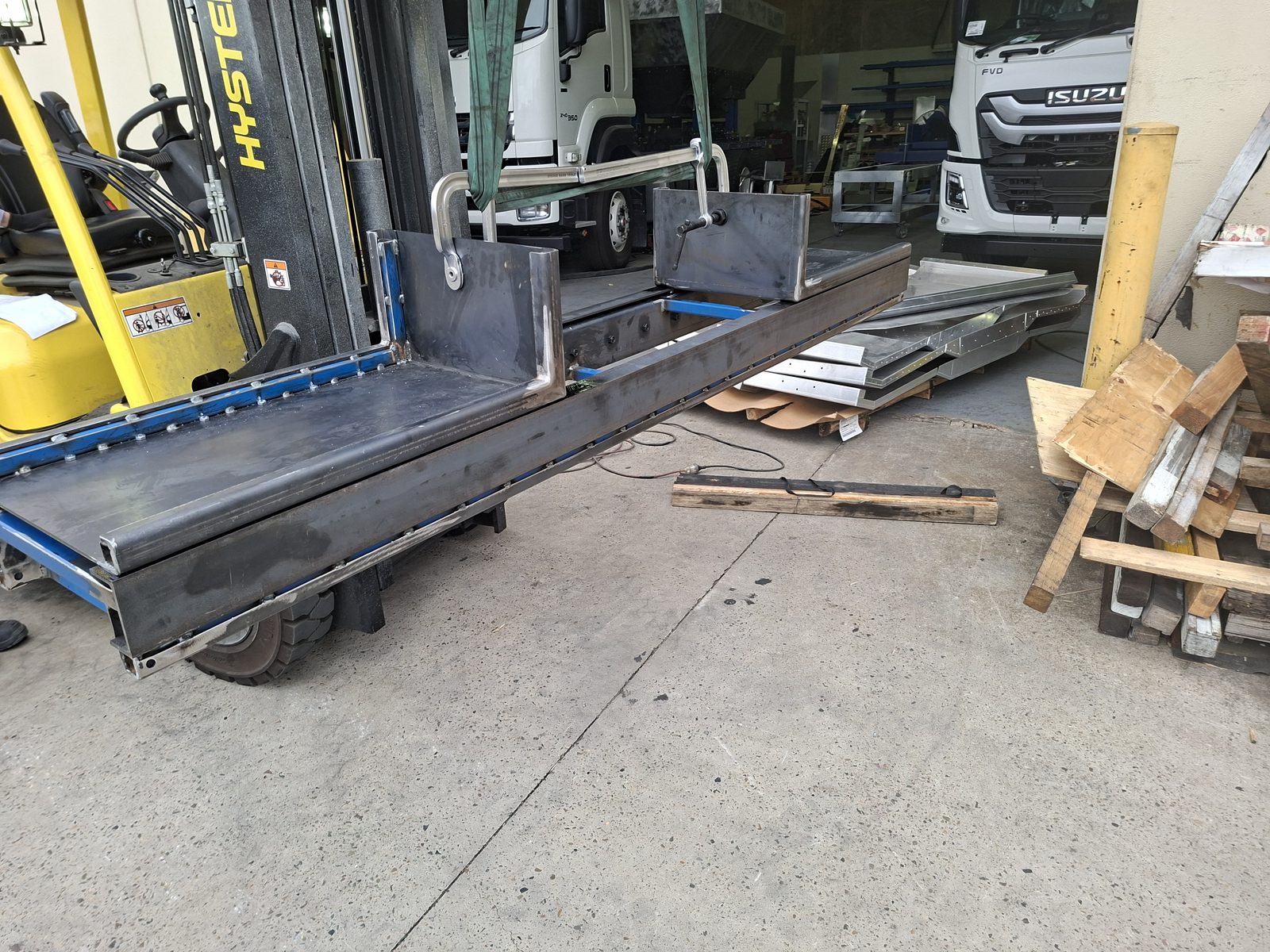 The welded spray bar frame subassembly on the workshop floor
